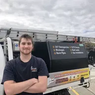 Plumber beside a service vehicle, Chelsea